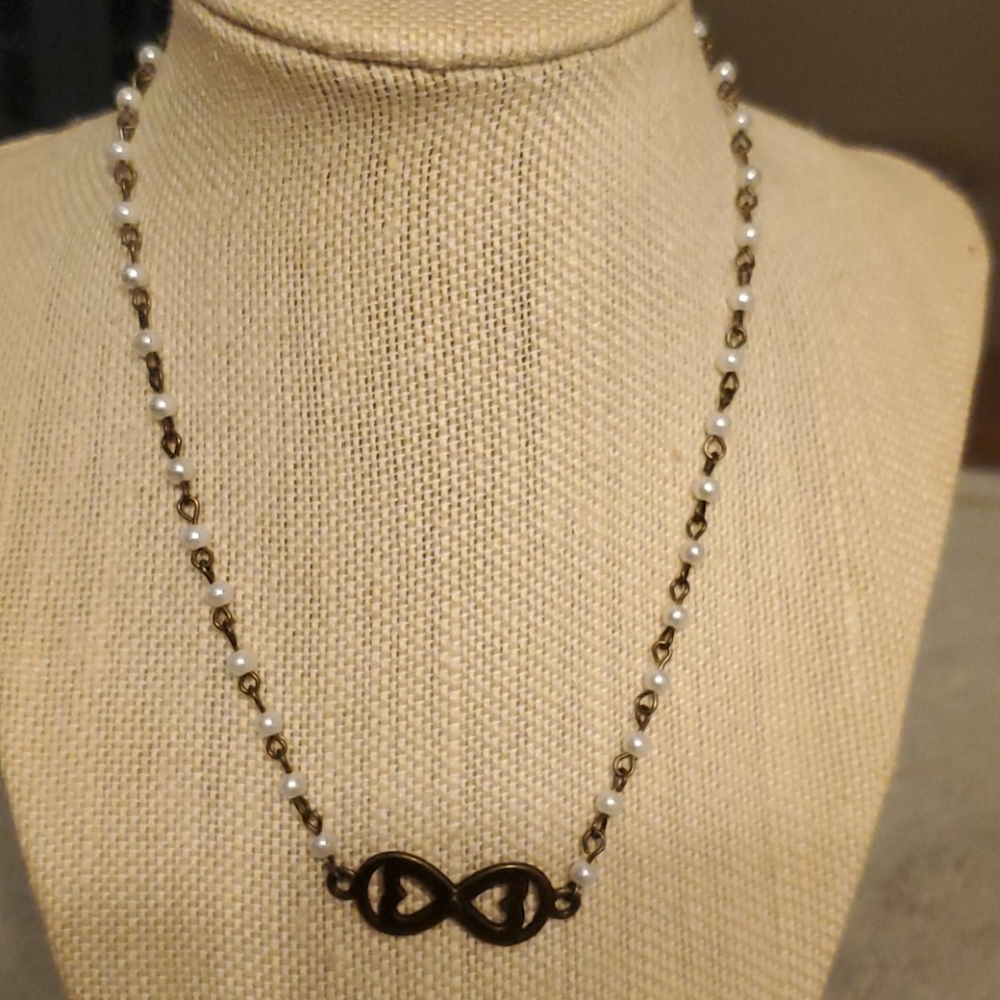Bronze and pearl necklace with Infiniti charm.